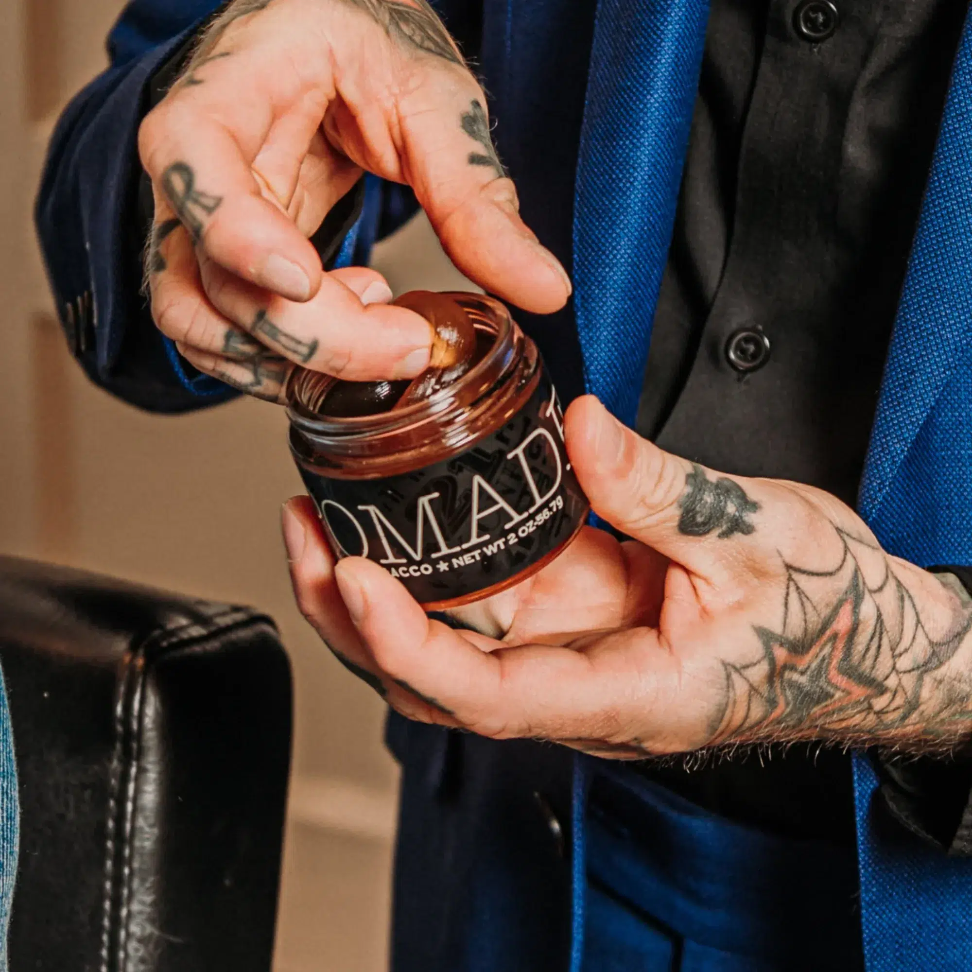 18.21 Man Made Sweet Tobacco Pomade - Medium Hold High Shine Men's Hair Styling Pomade - Man Holding Jar